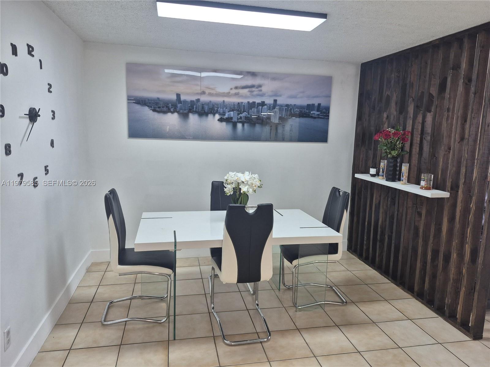 8405 Northwest 8th Street, Unit 304 Miami, FL 33126 - Photo 11 of 24 a view of a dining room with furniture and wooden floor