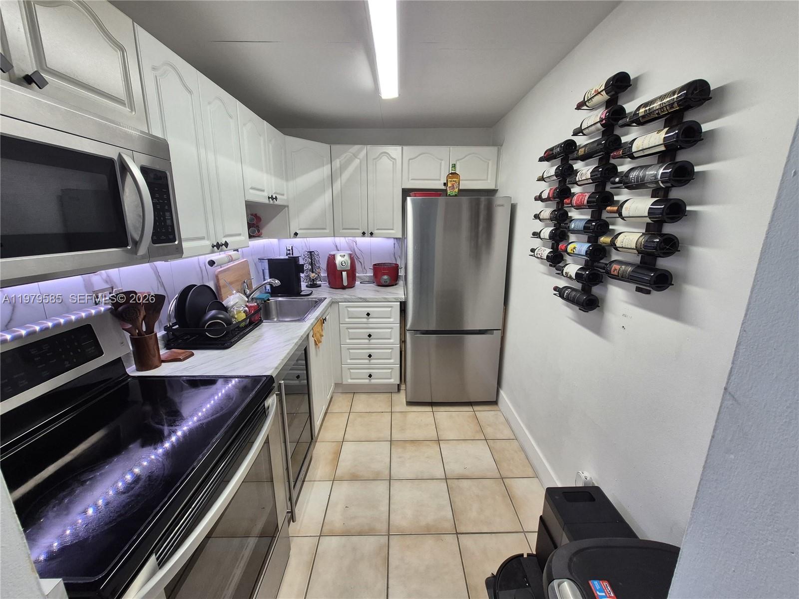 8405 Northwest 8th Street, Unit 304 Miami, FL 33126 - Photo 12 of 24 a kitchen with a sink and cabinets