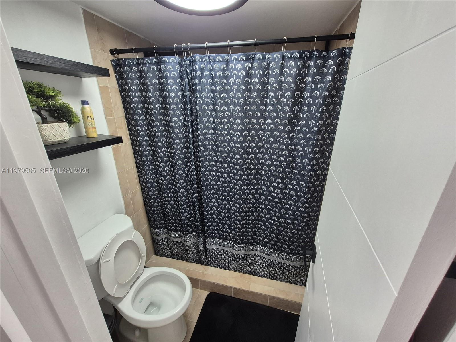 8405 Northwest 8th Street, Unit 304 Miami, FL 33126 - Photo 19 of 24 a bathroom with a toilet and a shower