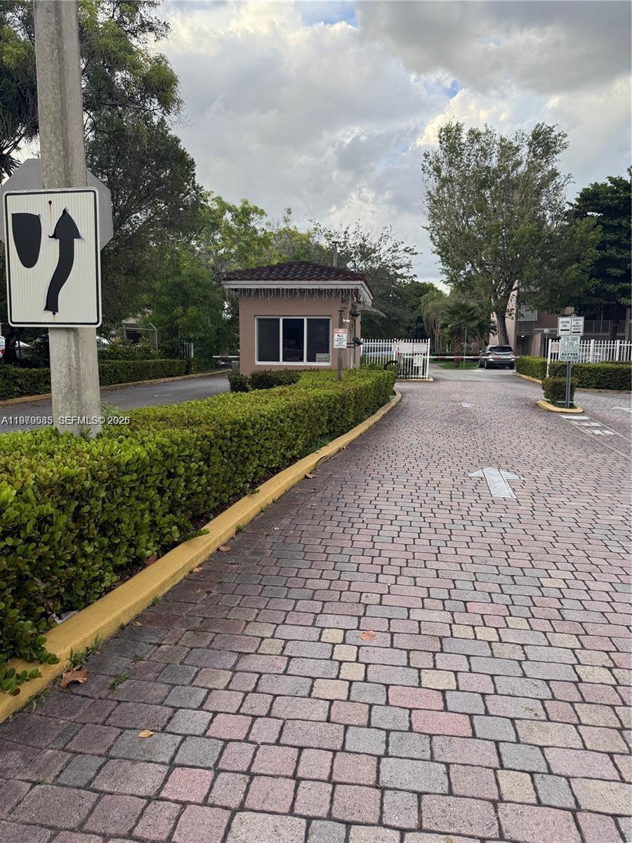 8405 Northwest 8th Street, Unit 304 Miami, FL 33126 - Photo 2 of 24 a front view of a house with a yard