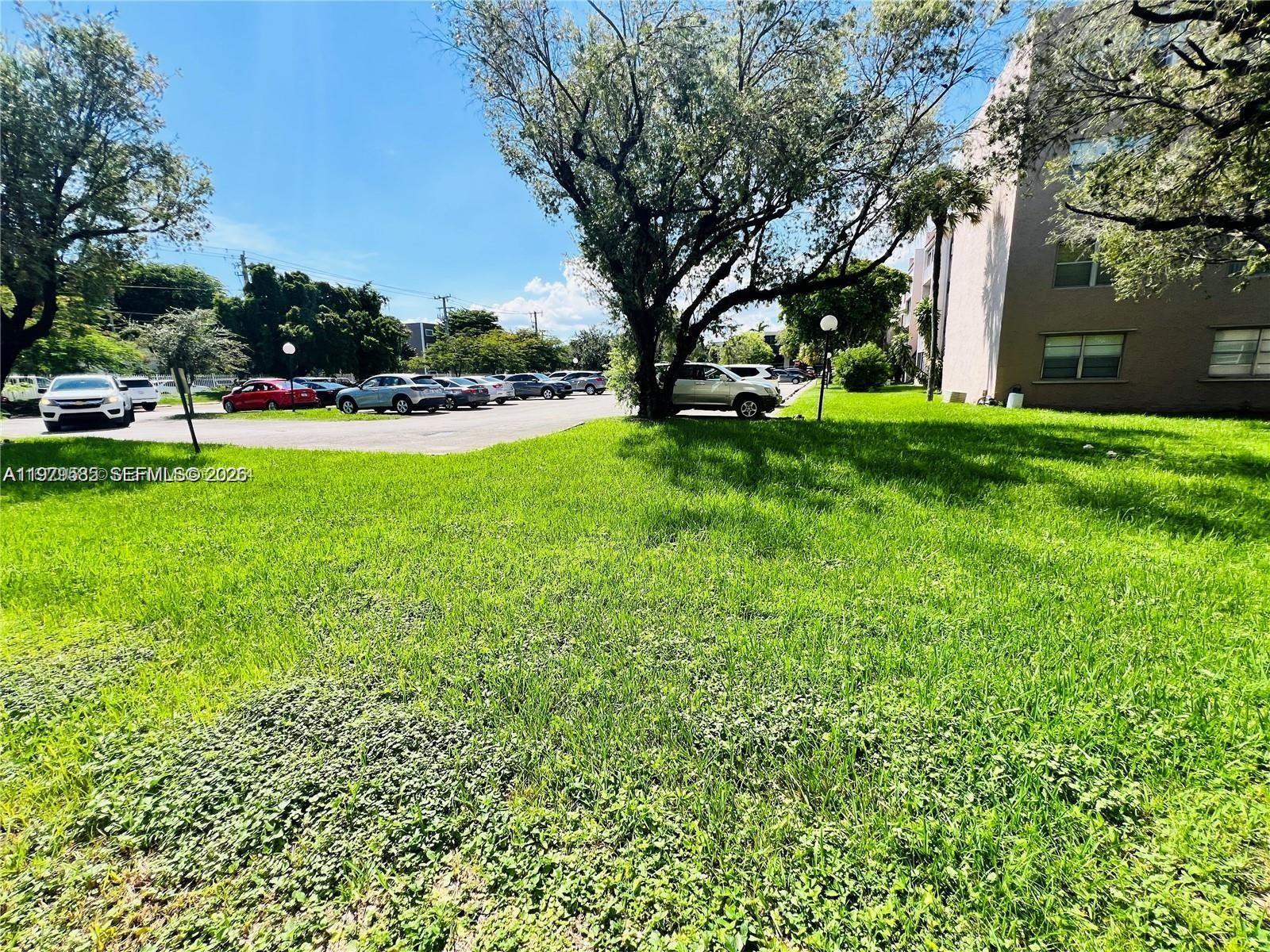 8405 Northwest 8th Street, Unit 304 Miami, FL 33126 - Photo 21 of 24 a view of yard with swimming pool and green space