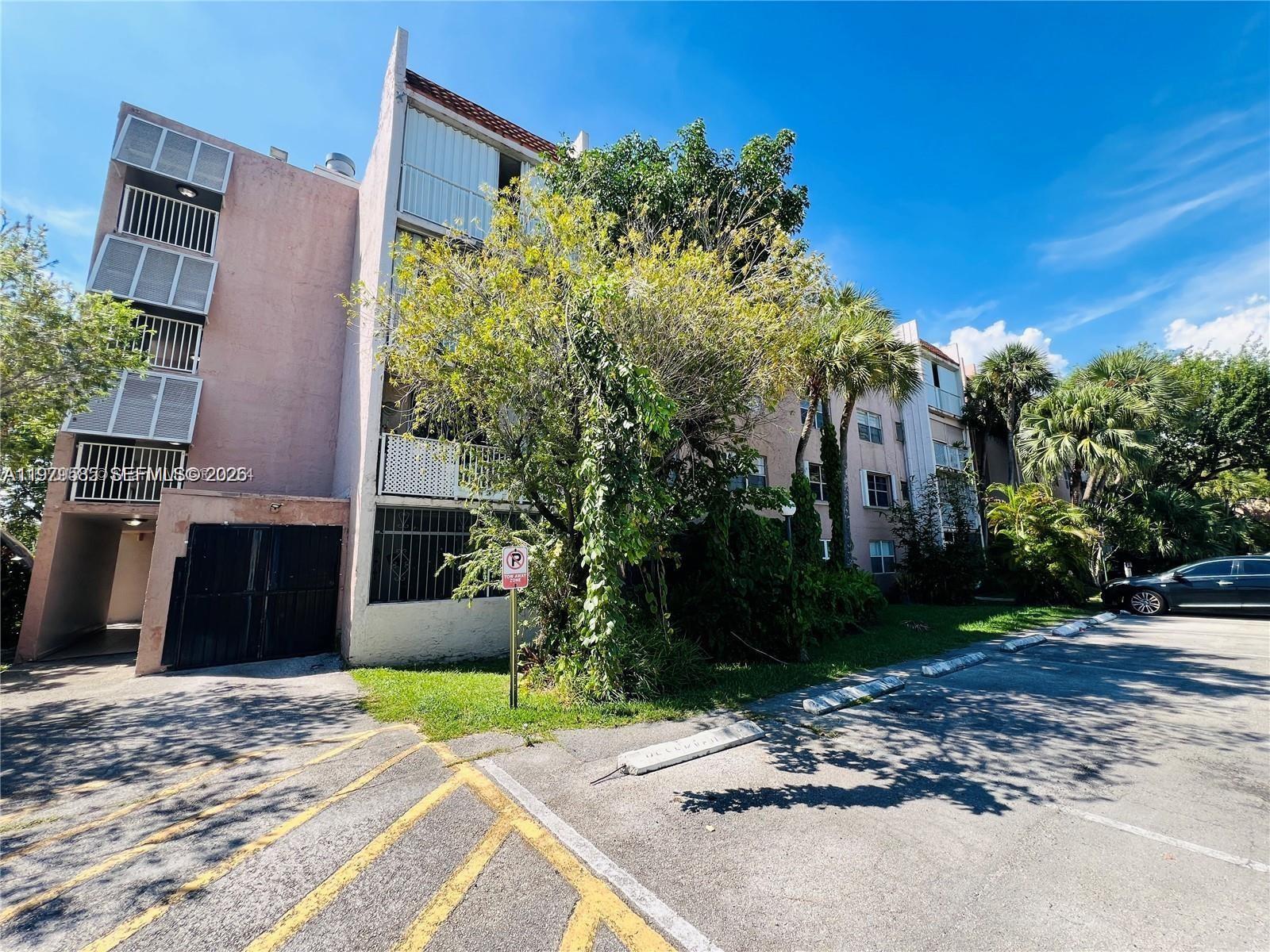 8405 Northwest 8th Street, Unit 304 Miami, FL 33126 - Photo 3 of 24 a view of a house with a yard