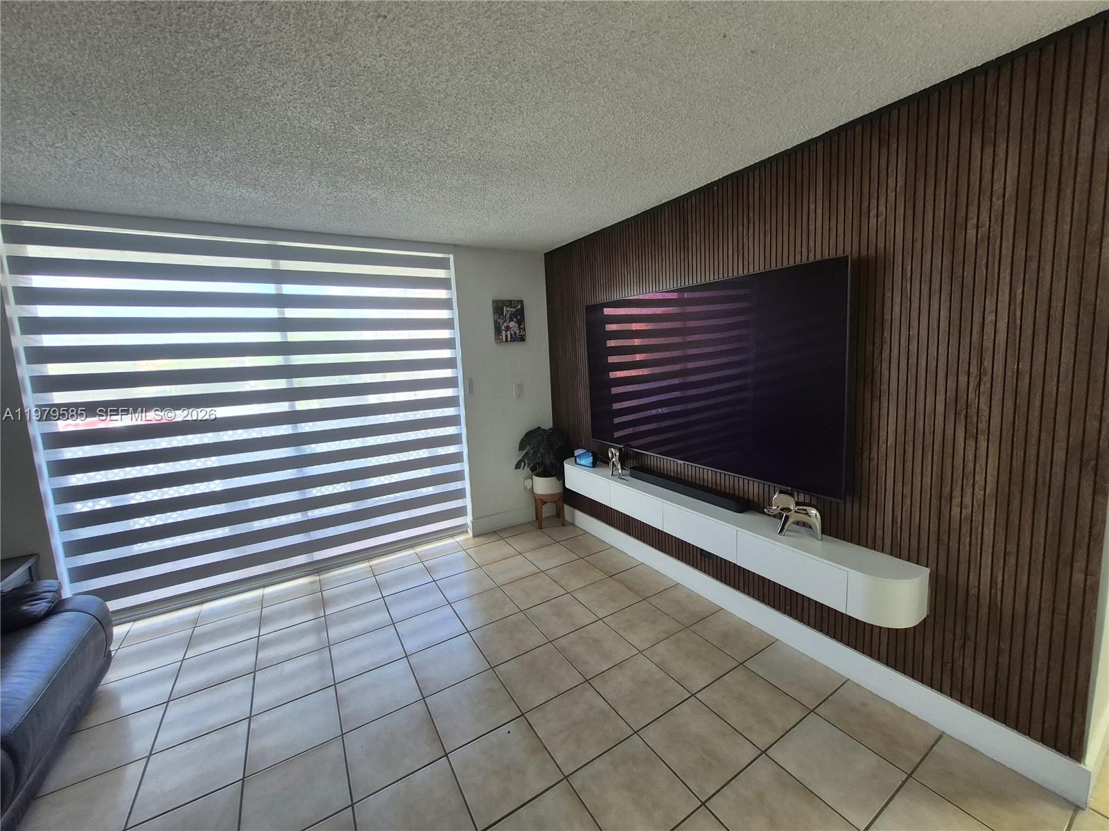 8405 Northwest 8th Street, Unit 304 Miami, FL 33126 - Photo 7 of 24 a view of room with window and a ceiling fan