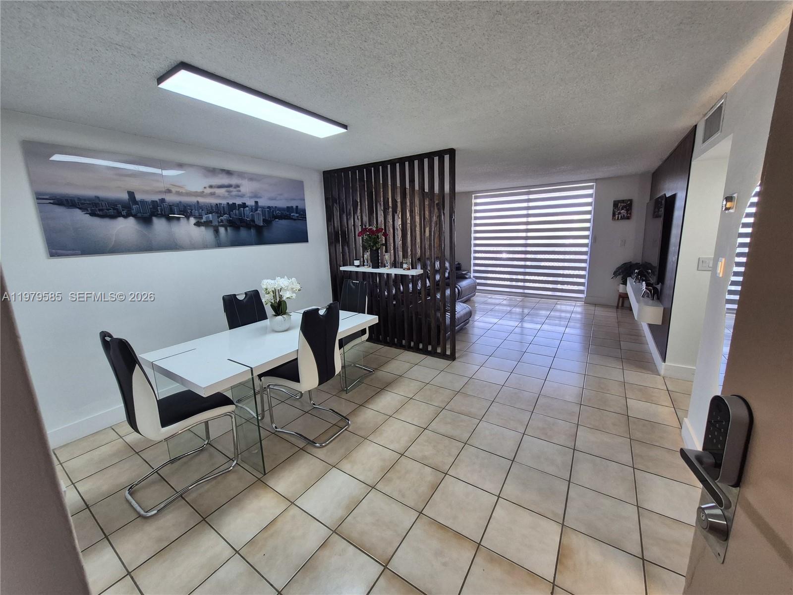 8405 Northwest 8th Street, Unit 304 Miami, FL 33126 - Photo 9 of 24 a living room with furniture and a window