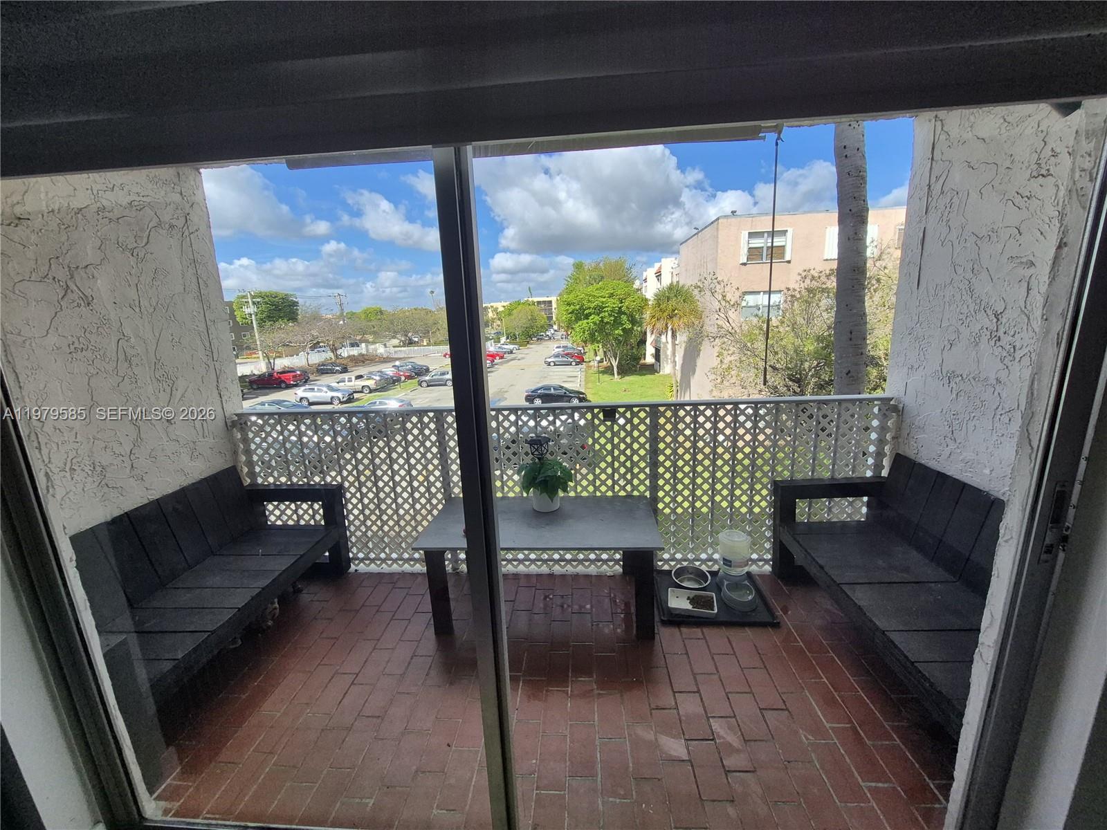 8405 Northwest 8th Street, Unit 304 Miami, FL 33126 - Photo 10 of 24 a sitting area with furniture and a large window