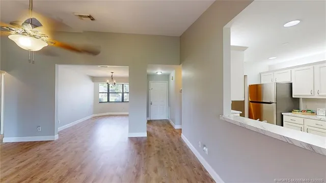 a view of a kitchen with a sink and a refrigerator