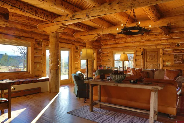 a living room with furniture a wooden floor and next to a window