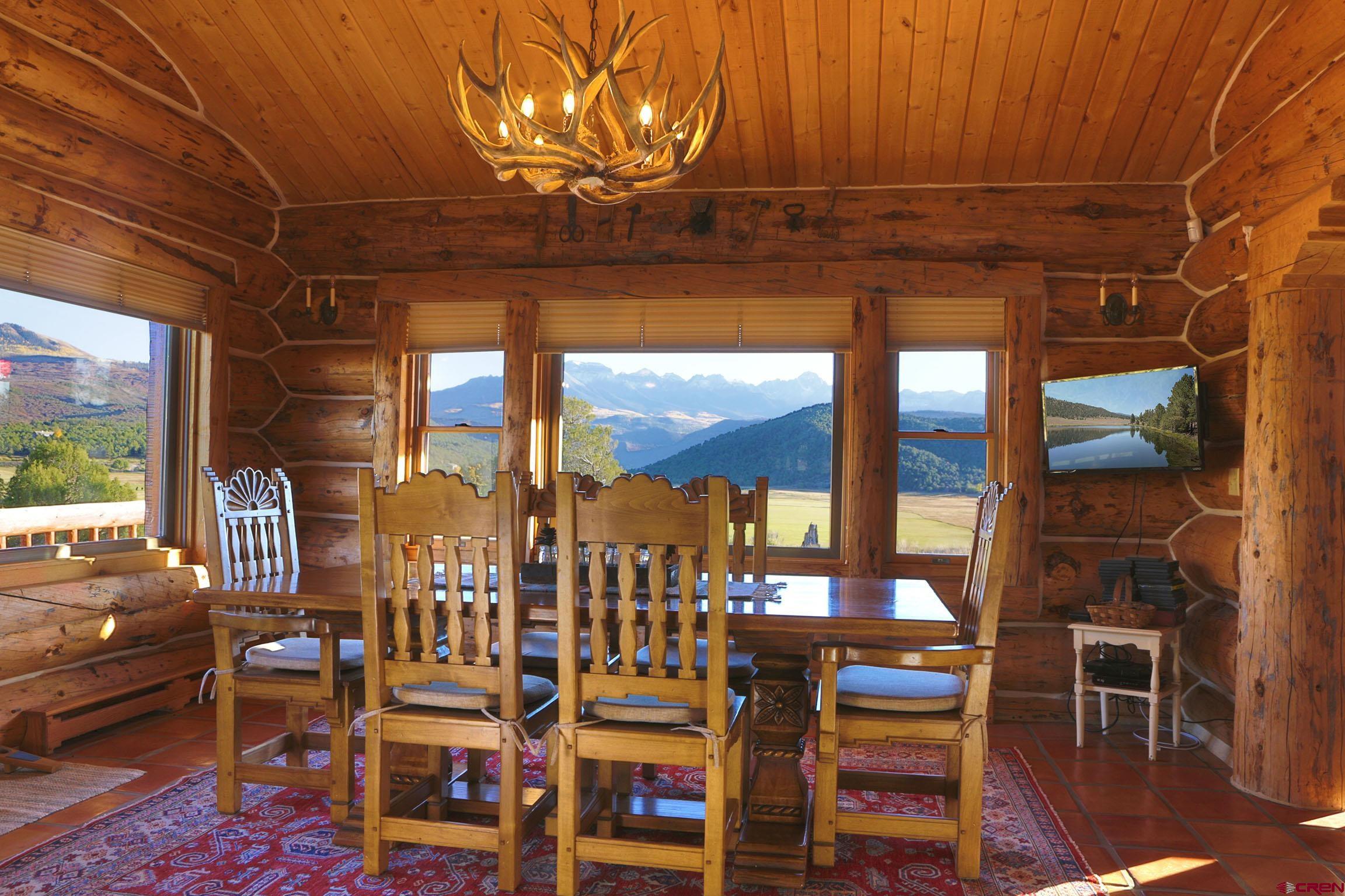 950 County Road 10 Ridgway, CO 81432 - Photo 15 of 32 a view of a dining room with furniture wooden floor and chandelier