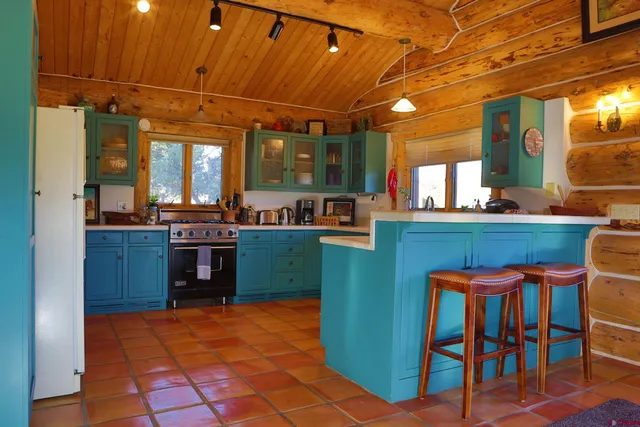 a kitchen with granite countertop a sink and a stove