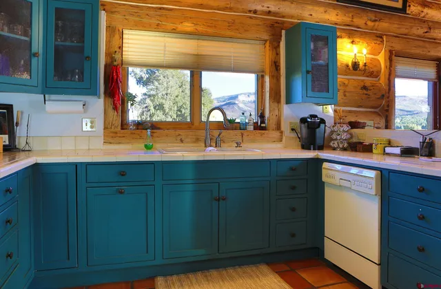 a kitchen with granite countertop wooden cabinets and a sink
