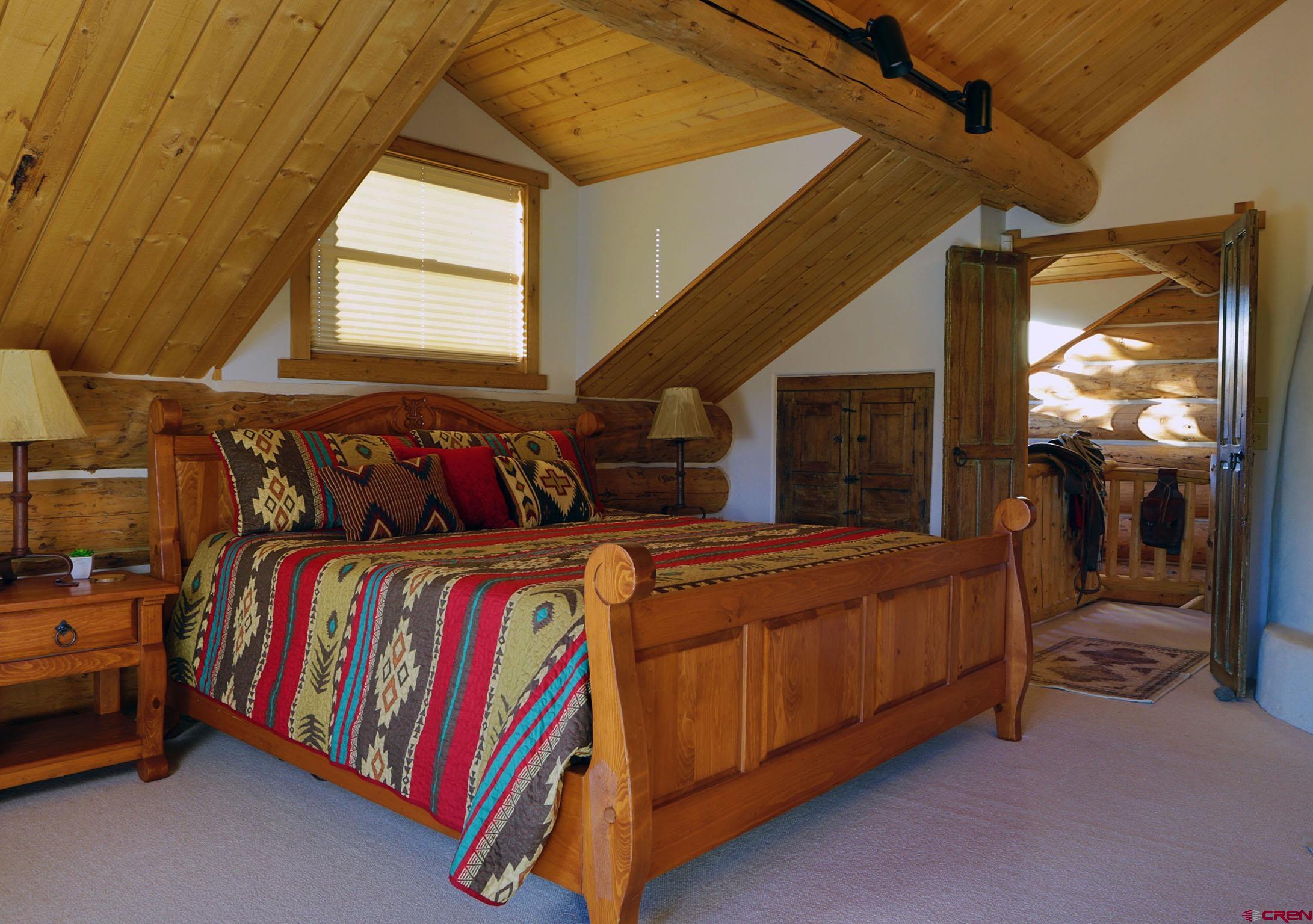 950 County Road 10 Ridgway, CO 81432 - Photo 25 of 32 a bedroom with a bed and window