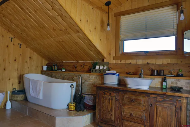 a kitchen with granite countertop a sink a stove and wooden cabinets