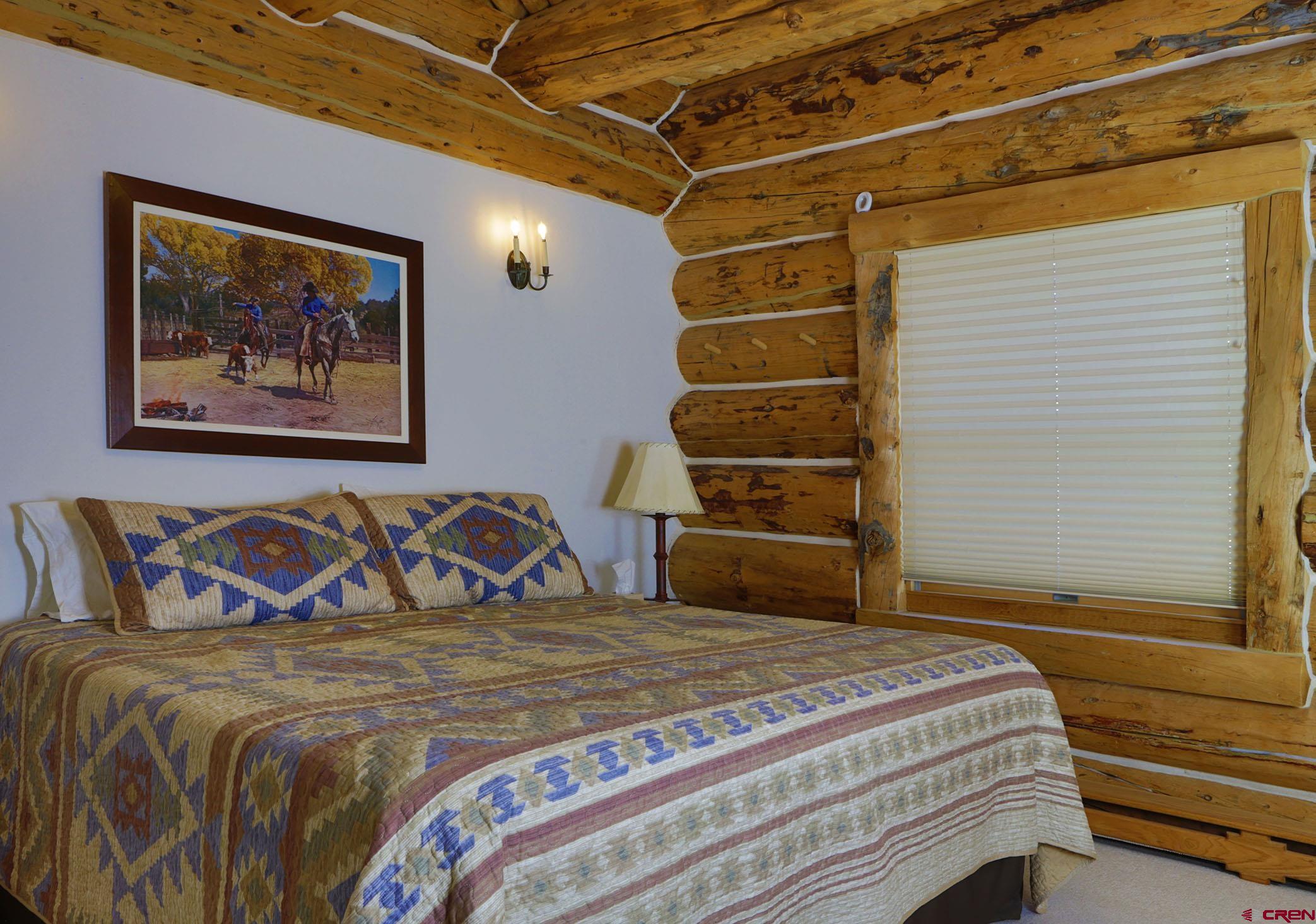 950 County Road 10 Ridgway, CO 81432 - Photo 28 of 32 a bedroom with a bed and a painting on the wall