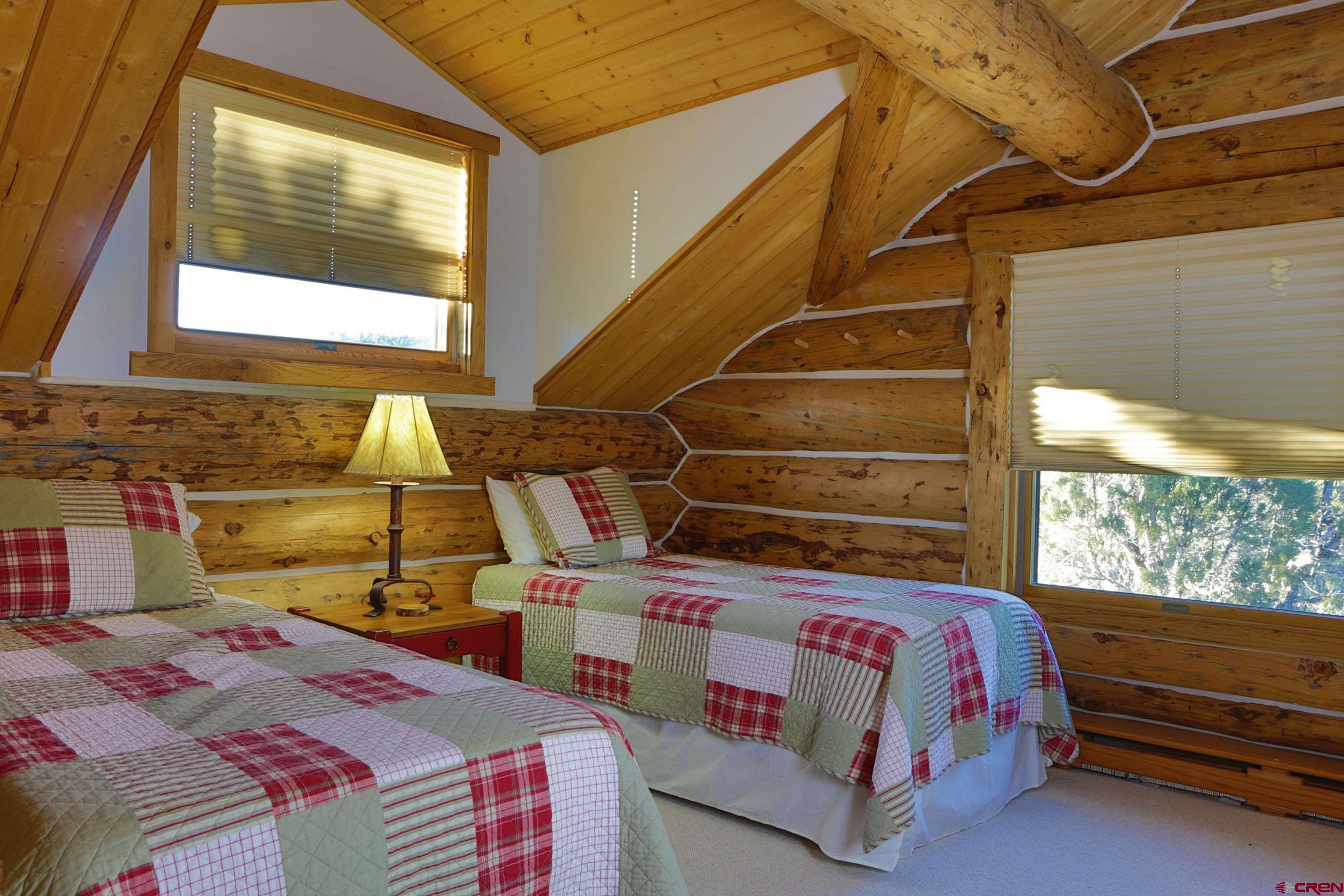 950 County Road 10 Ridgway, CO 81432 - Photo 30 of 32 a bed room with a bed and a window