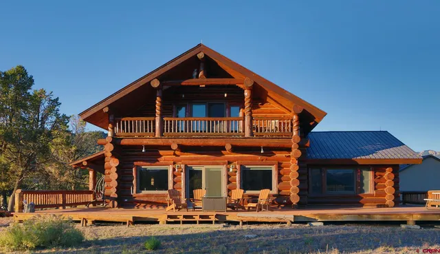 a front view of a house with porch yard and outdoor seating