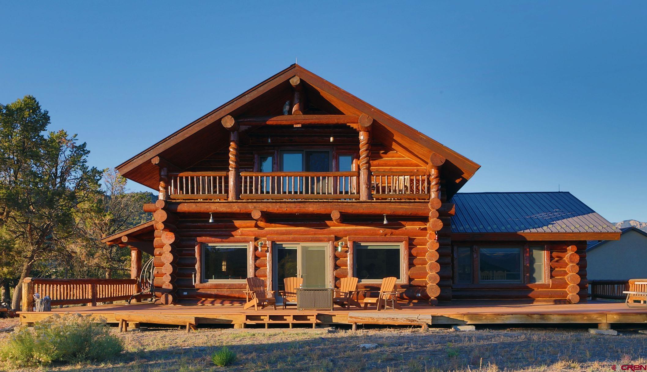 950 County Road 10 Ridgway, CO 81432 - Photo 3 of 32 a front view of a house with porch yard and outdoor seating