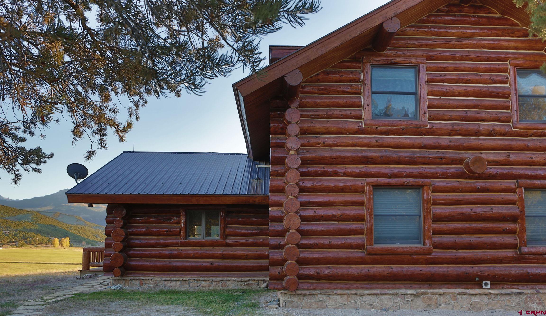 950 County Road 10 Ridgway, CO 81432 - Photo 4 of 32 a backyard of a house with barbeque oven and trees