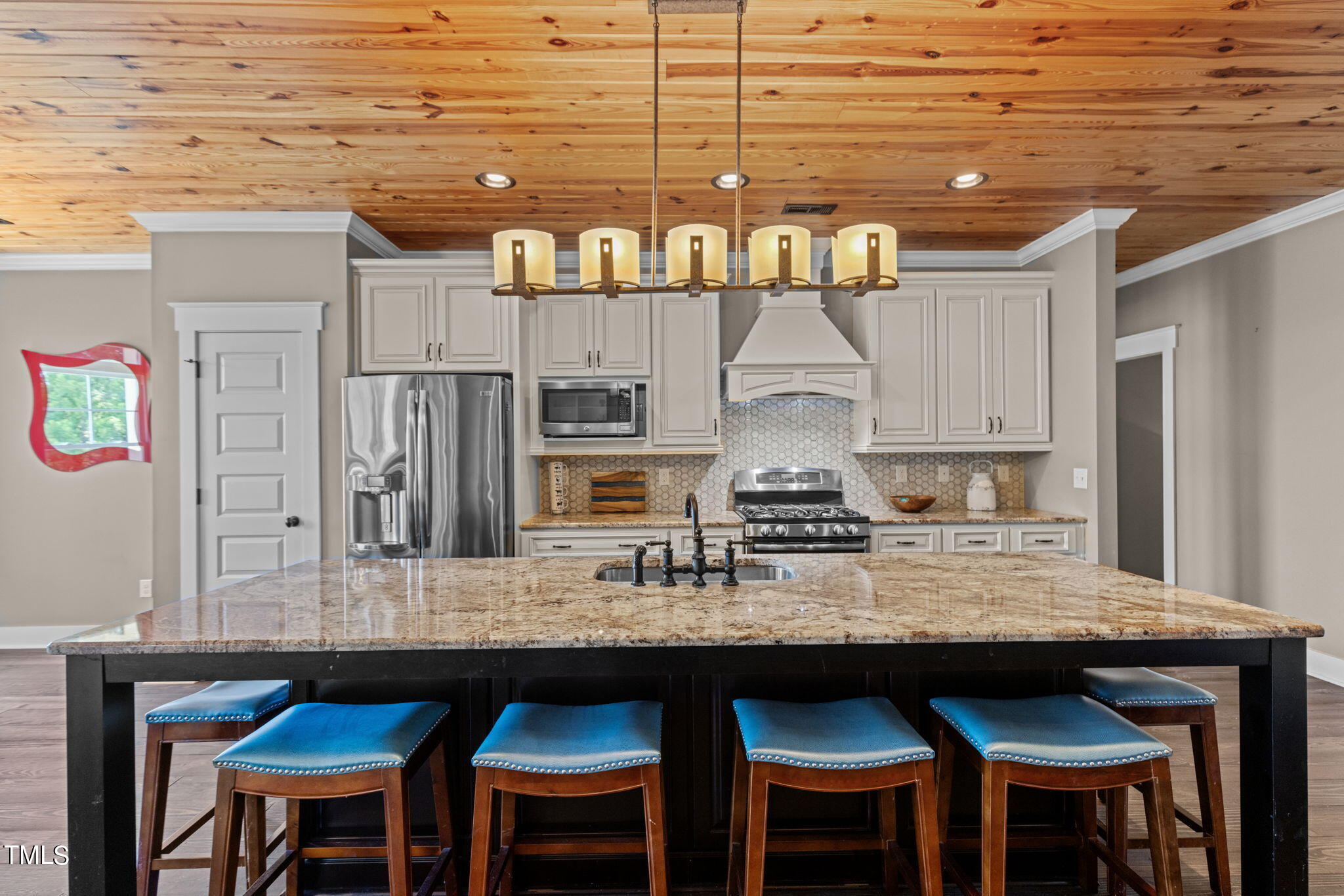 186 Polaris Point Semora, NC 27343 - Photo 16 of 73 a kitchen with granite countertop a table chairs stove and cabinets