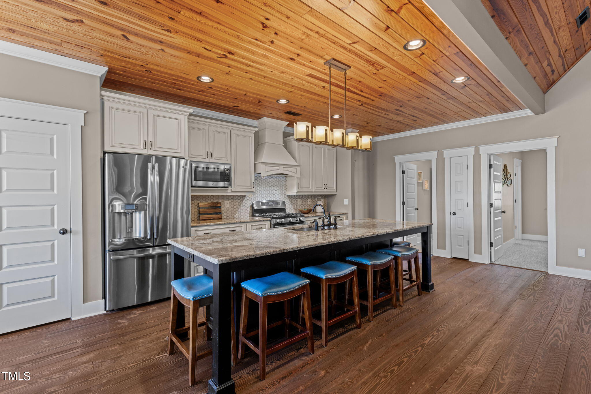 186 Polaris Point Semora, NC 27343 - Photo 17 of 73 a kitchen with stainless steel appliances granite countertop a table chairs stove and refrigerator