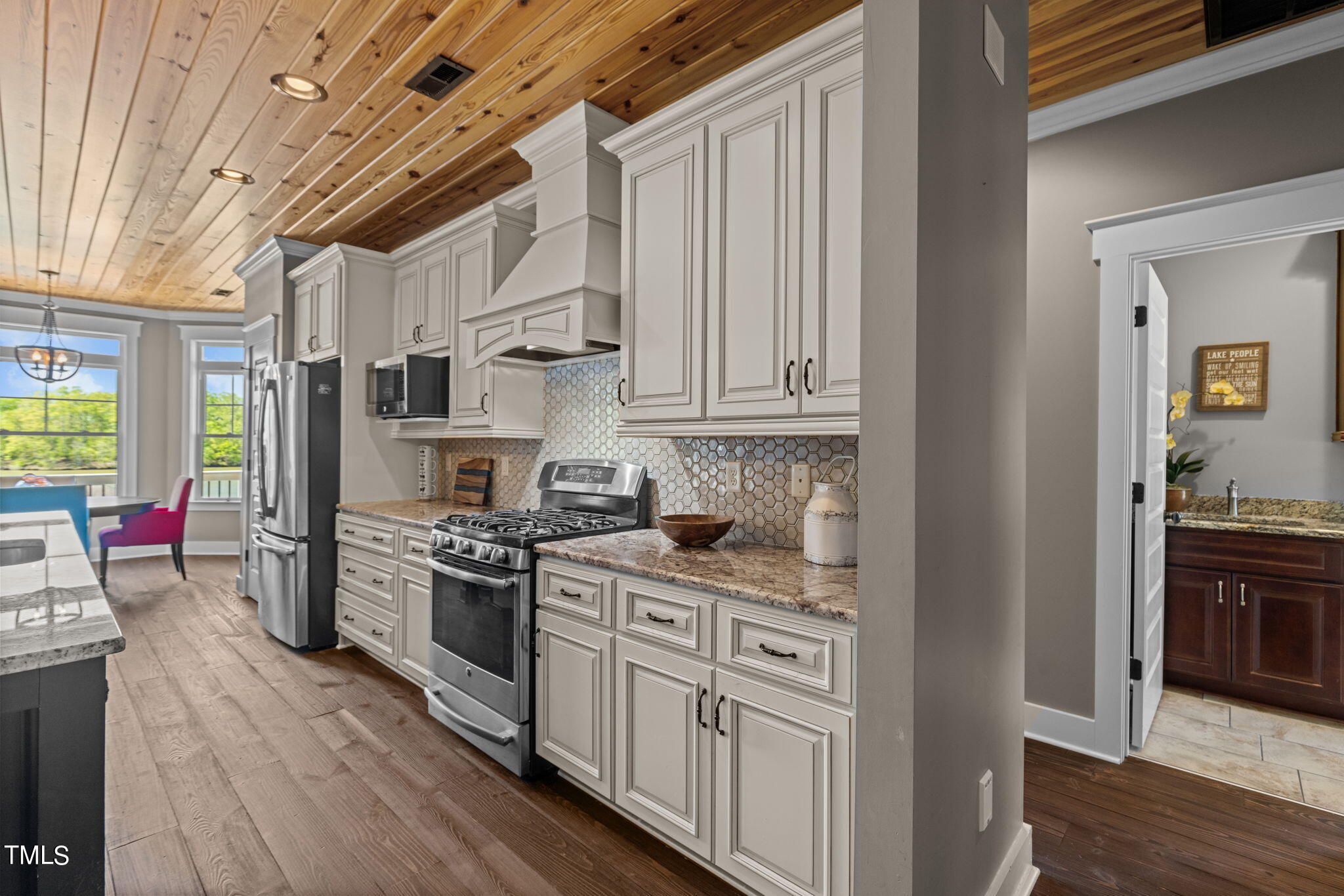186 Polaris Point Semora, NC 27343 - Photo 19 of 73 a kitchen with stainless steel appliances granite countertop a stove a sink dishwasher and a refrigerator with wooden floor