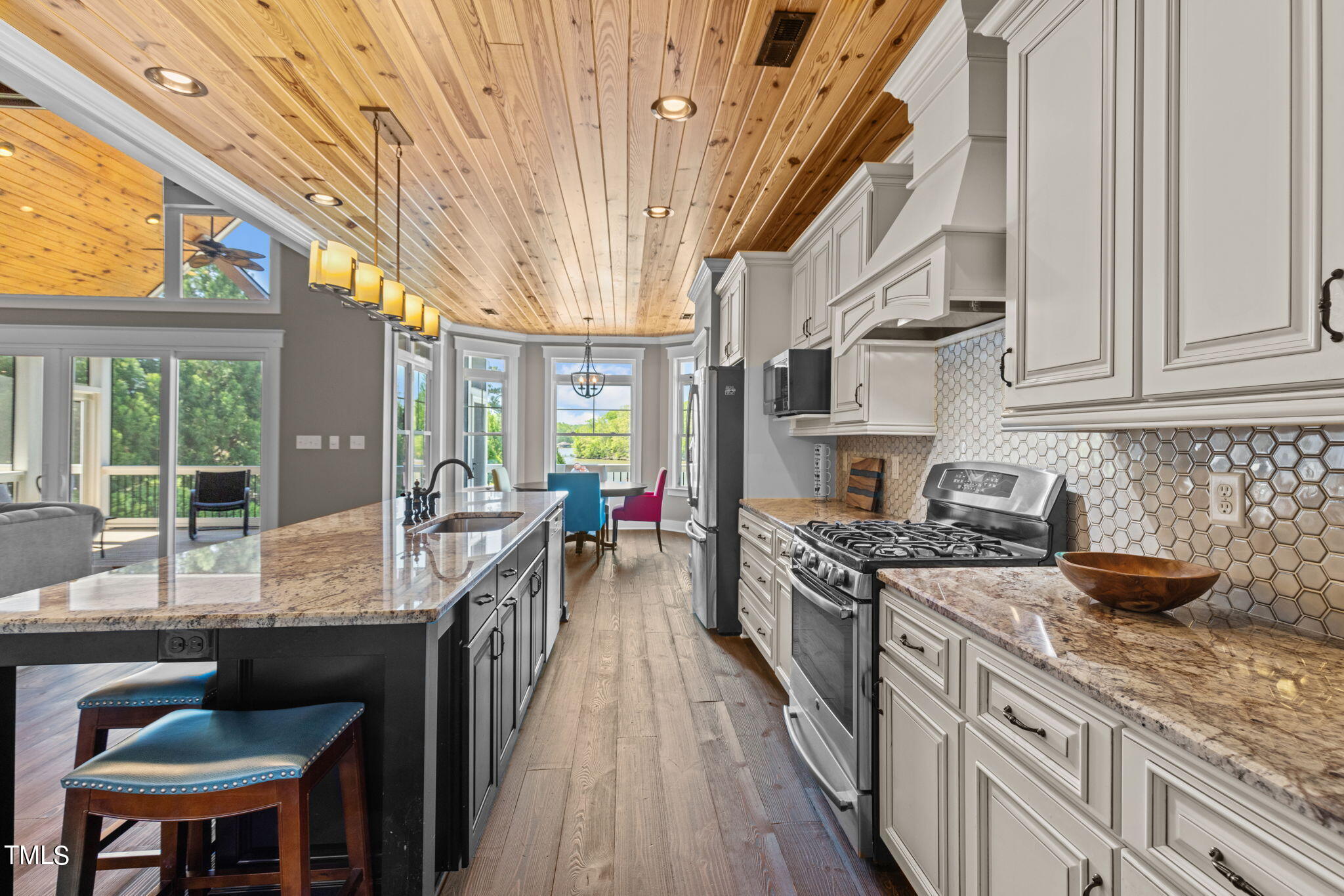 186 Polaris Point Semora, NC 27343 - Photo 20 of 73 a kitchen with stainless steel appliances granite countertop a stove a sink dishwasher and cabinets with wooden floor
