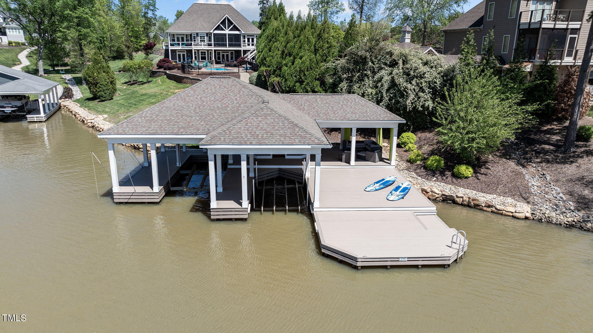 186 Polaris Point Semora, NC 27343 - Photo 7 of 73 a white house with pool table and chairs next to a yard