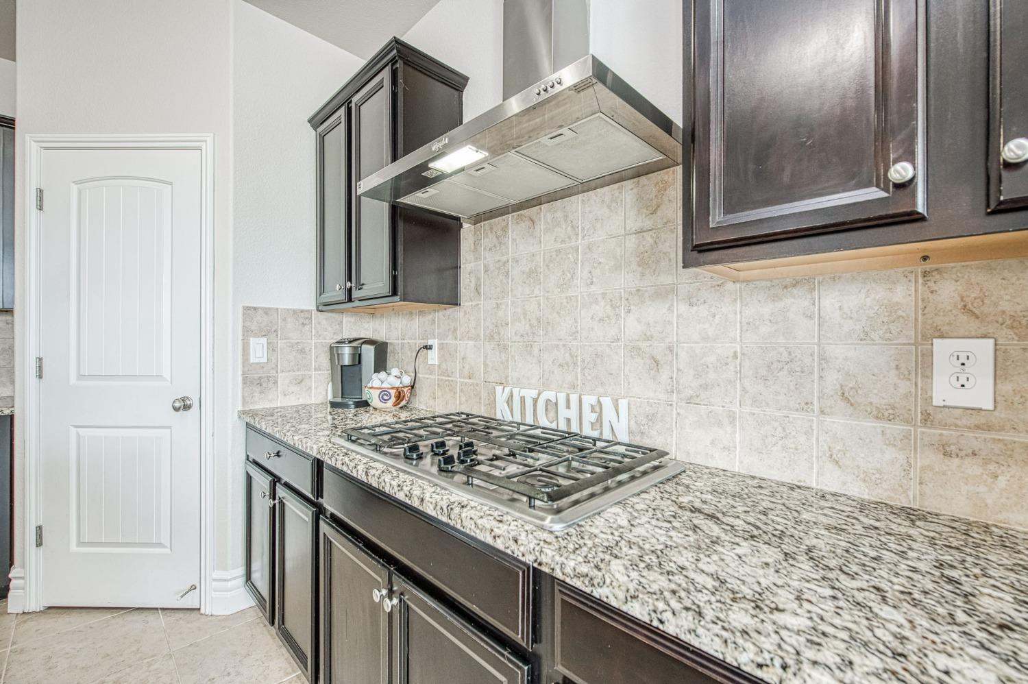 3036 Portals Avenue Clovis, CA 93619 - Photo 22 of 53 a kitchen with a granite countertop sink and cabinets
