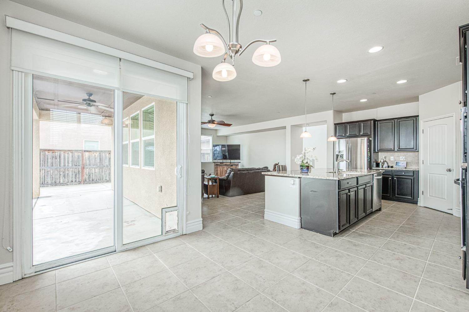 3036 Portals Avenue Clovis, CA 93619 - Photo 26 of 53 a view of a kitchen with kitchen island a large counter space cabinets and stainless steel appliances