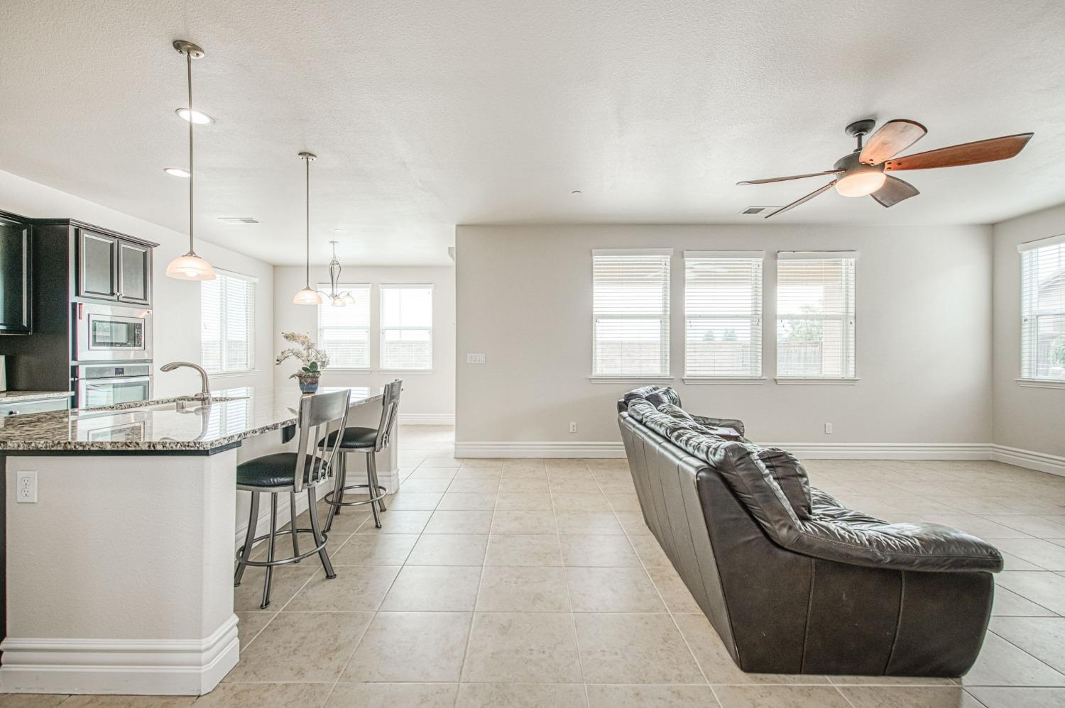 3036 Portals Avenue Clovis, CA 93619 - Photo 27 of 53 a living room with granite countertop furniture a dining table and chairs