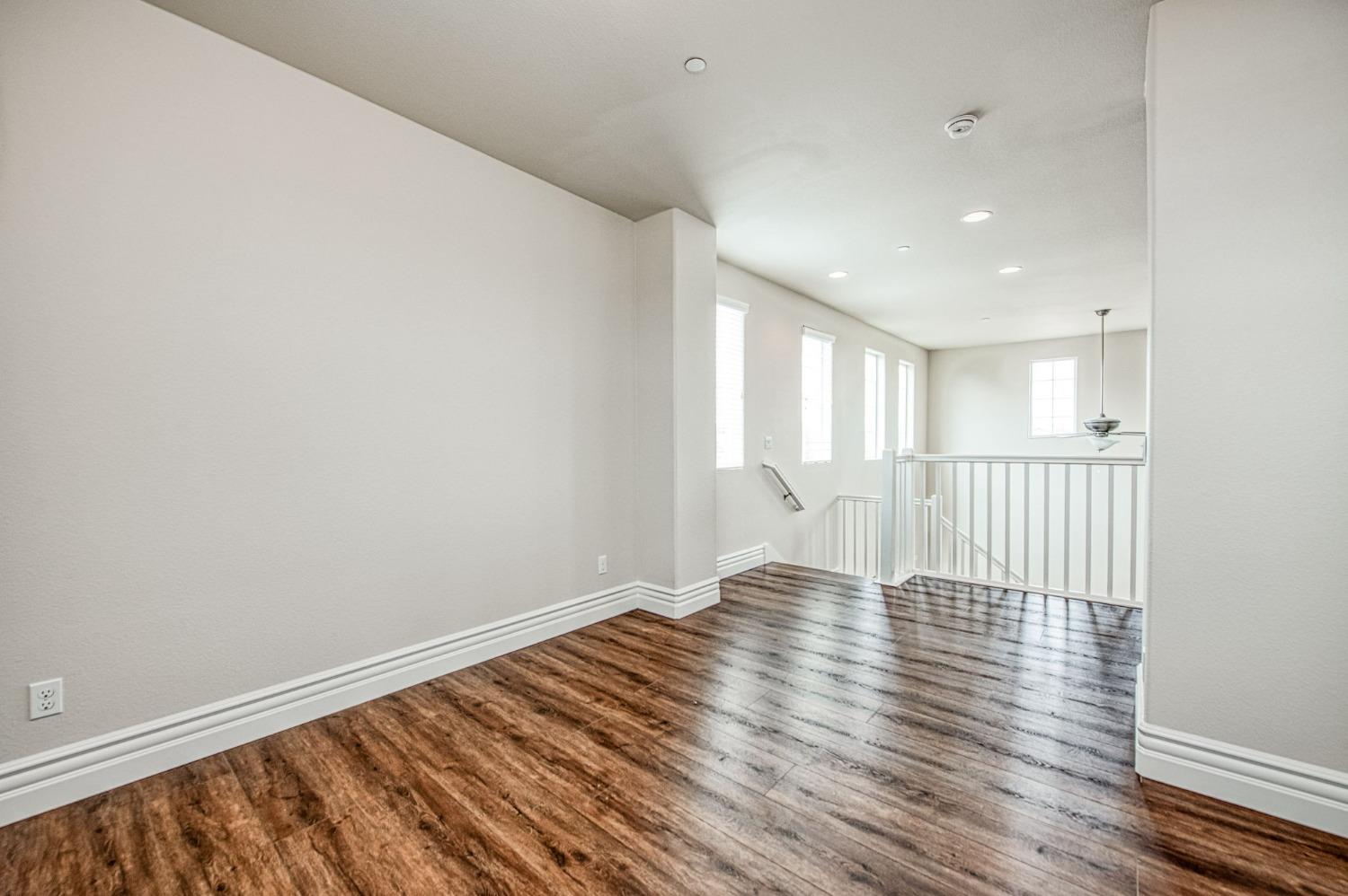 3036 Portals Avenue Clovis, CA 93619 - Photo 30 of 53 a view of an empty room with wooden floor