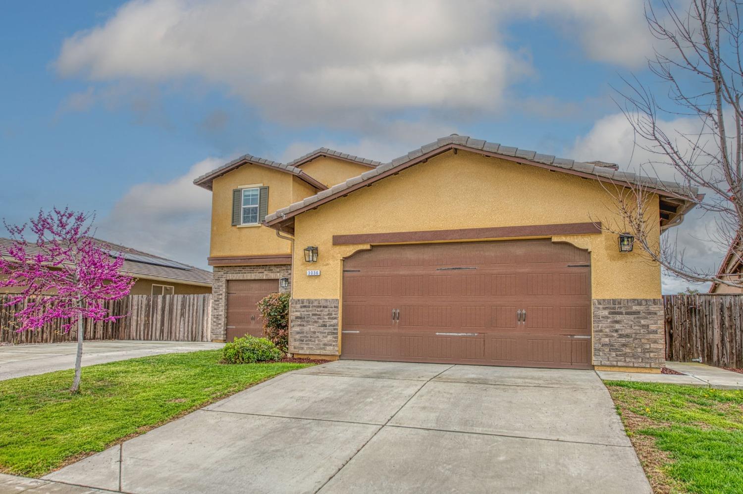 3036 Portals Avenue Clovis, CA 93619 - Photo 3 of 53 a view of a house with a yard plants and large tree