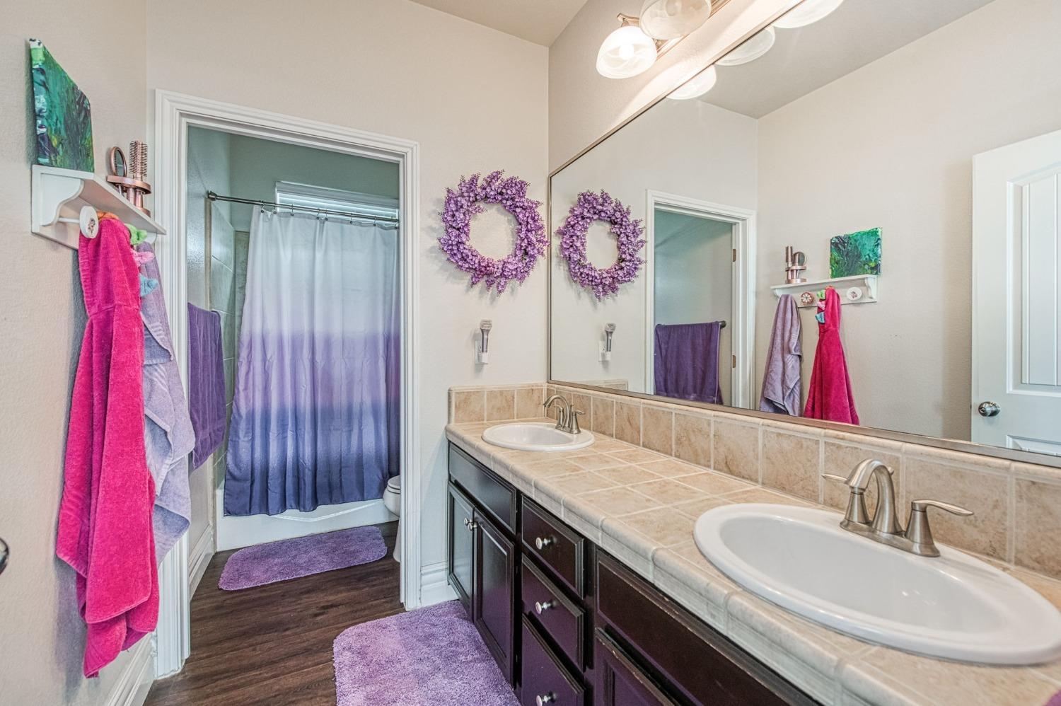 3036 Portals Avenue Clovis, CA 93619 - Photo 32 of 53 a bathroom with a sink vanity and a mirror