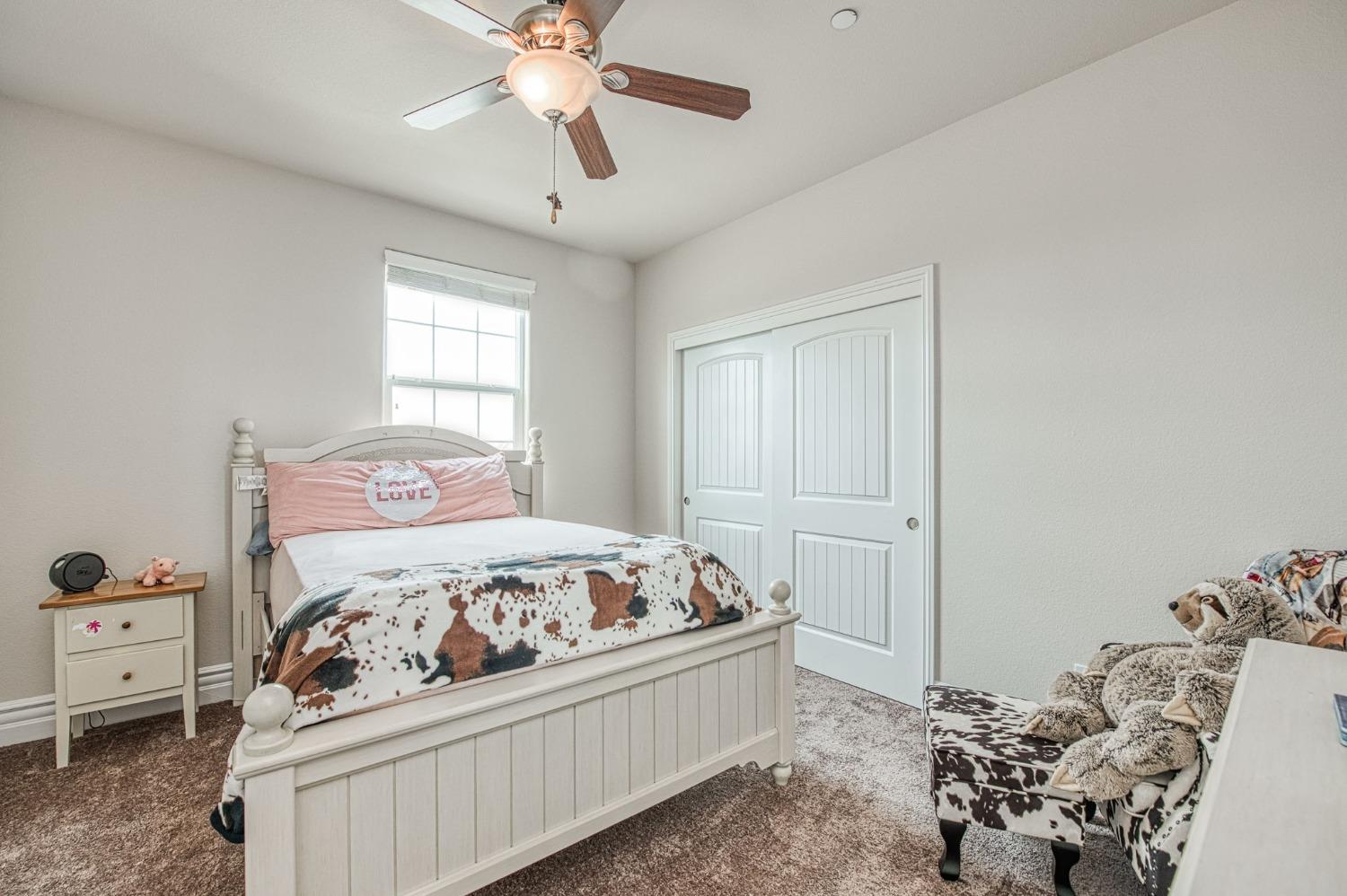 3036 Portals Avenue Clovis, CA 93619 - Photo 35 of 53 a bedroom with a bed and a chandelier