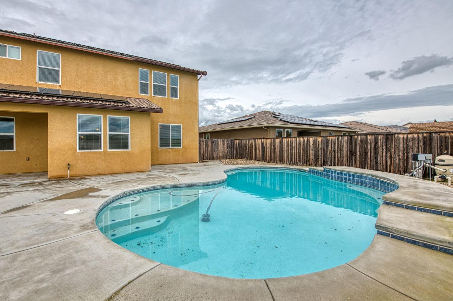 3036 Portals Avenue Clovis, CA 93619 - Photo 46 of 53 a view of a house with a swimming pool