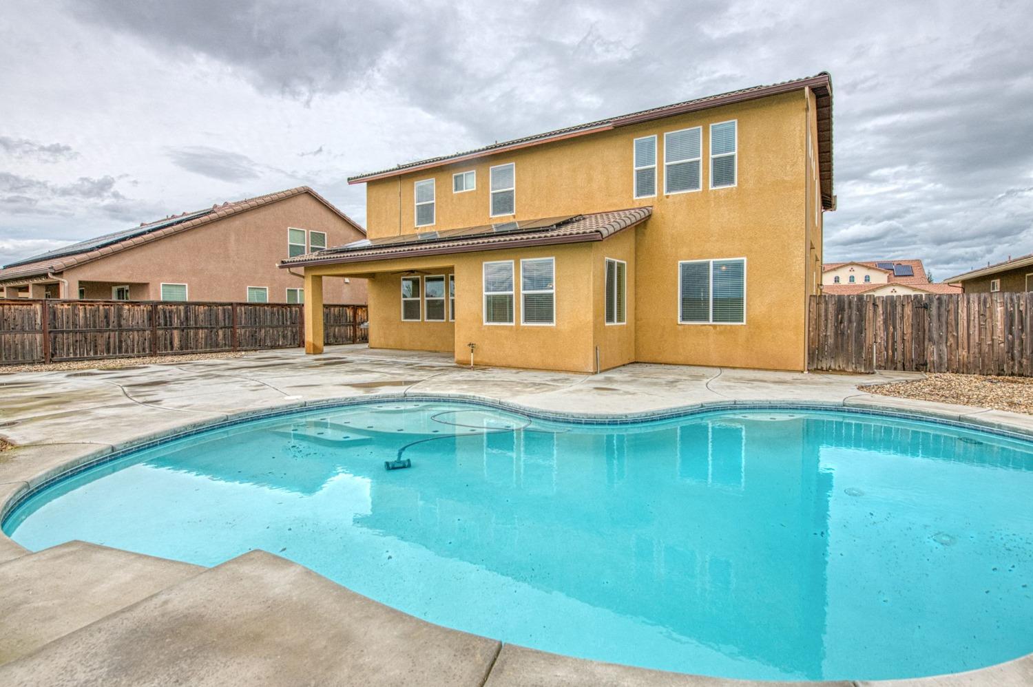 3036 Portals Avenue Clovis, CA 93619 - Photo 47 of 53 a front view of a house with swimming pool
