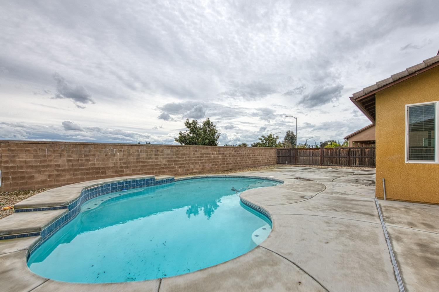 3036 Portals Avenue Clovis, CA 93619 - Photo 49 of 53 a view of a swimming pool with a yard