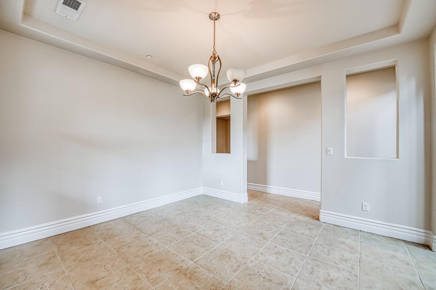 3036 Portals Avenue Clovis, CA 93619 - Photo 6 of 53 a view of a chandelier in a room