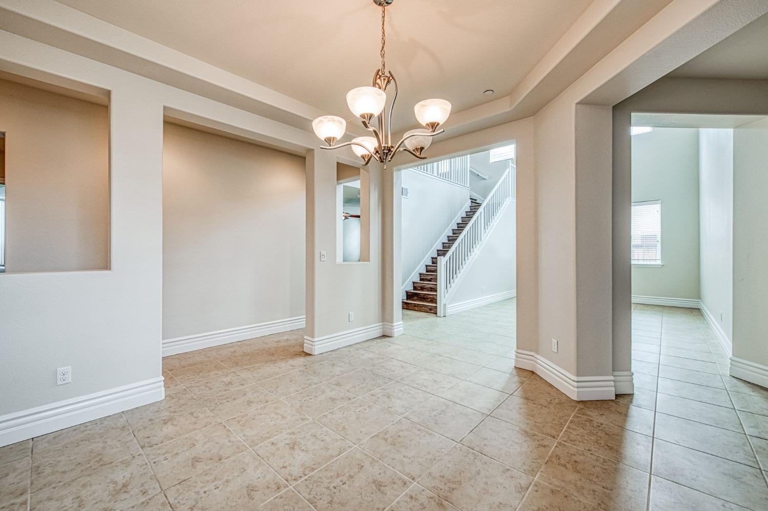 3036 Portals Avenue Clovis, CA 93619 - Photo 8 of 53 a view of a hallway with a chandelier fan and livingroom view