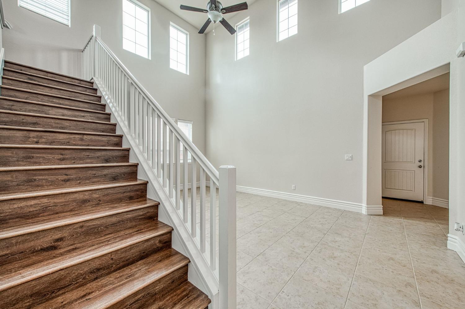 3036 Portals Avenue Clovis, CA 93619 - Photo 10 of 53 a view of a hallway with wooden floor and entryway