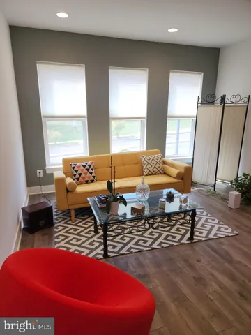 a living room with furniture rug and window