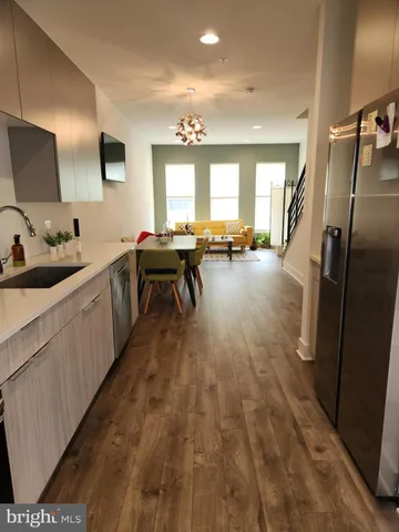 a kitchen with sink stove and refrigerator