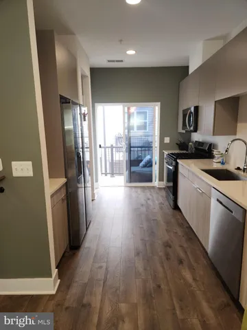 a kitchen with stainless steel appliances a refrigerator stove and sink