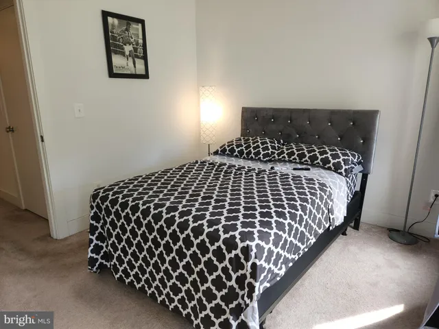 a bedroom with bed and a window