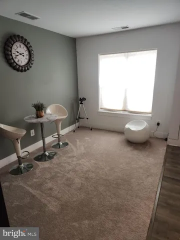 a view of a room with a window and a chair