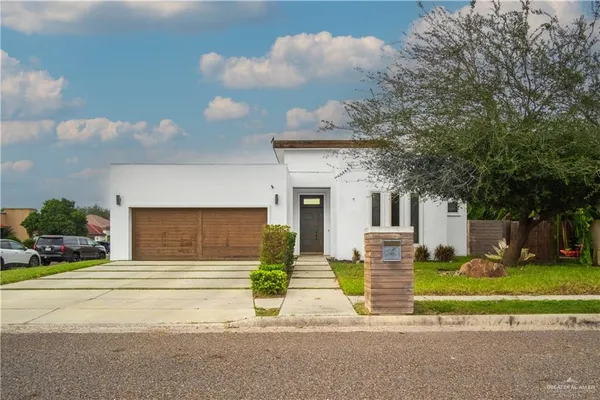 a front view of a house with a yard garage and outdoor seating