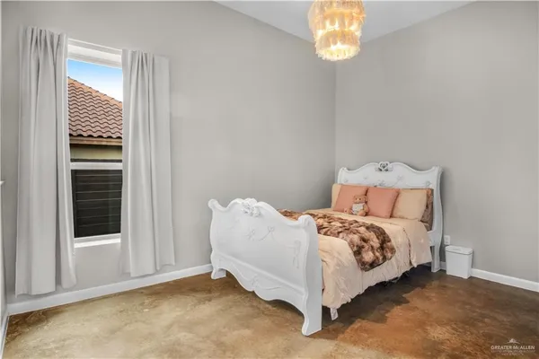 a bed sitting in a bedroom next to a window