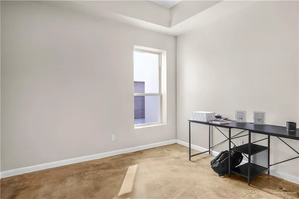 a view of a room with rack and a window