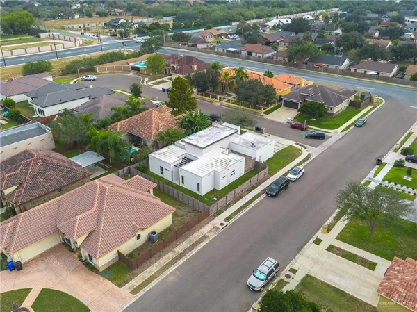 an aerial view of a house with a garden and lake view