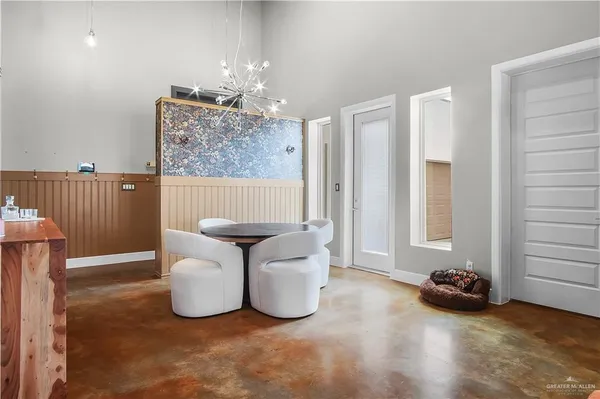 a living room with furniture and a chandelier