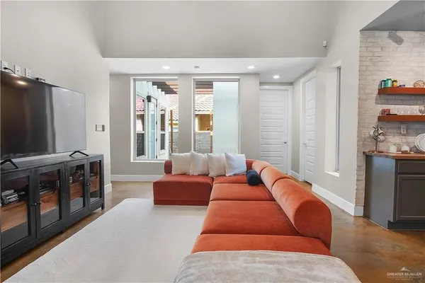 a living room with furniture a flat screen tv and a fireplace